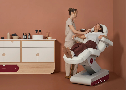 Woman receiving a massage in a modern massage chair with a wooden cabinet in the background.
