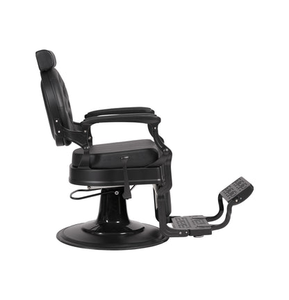 Black barber chair with adjustable armrests and footrest on a white background