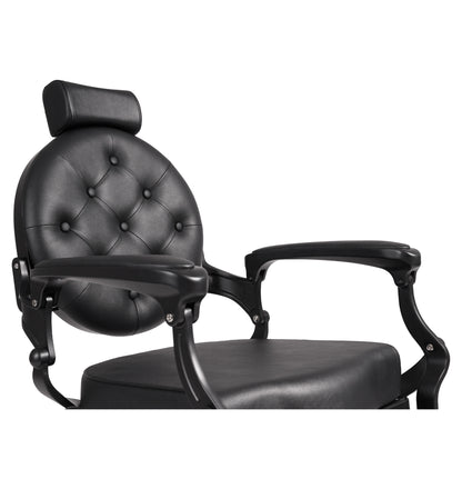 Black barber chair with buttoned backrest on a white background